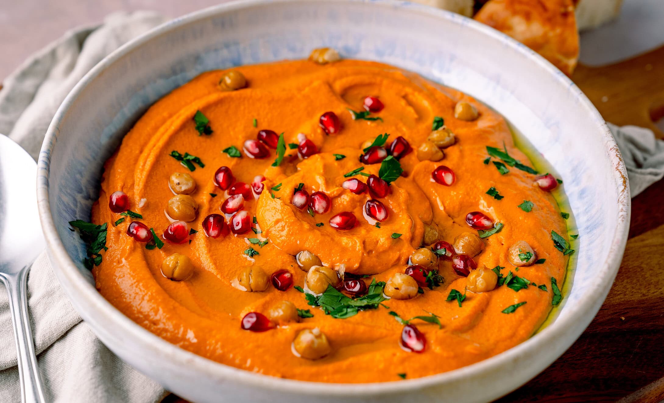 Leckeres Rezept: gerösteter Paprika Hummus mit Granatapfel, ideal zum Dippen oder als Beilage.