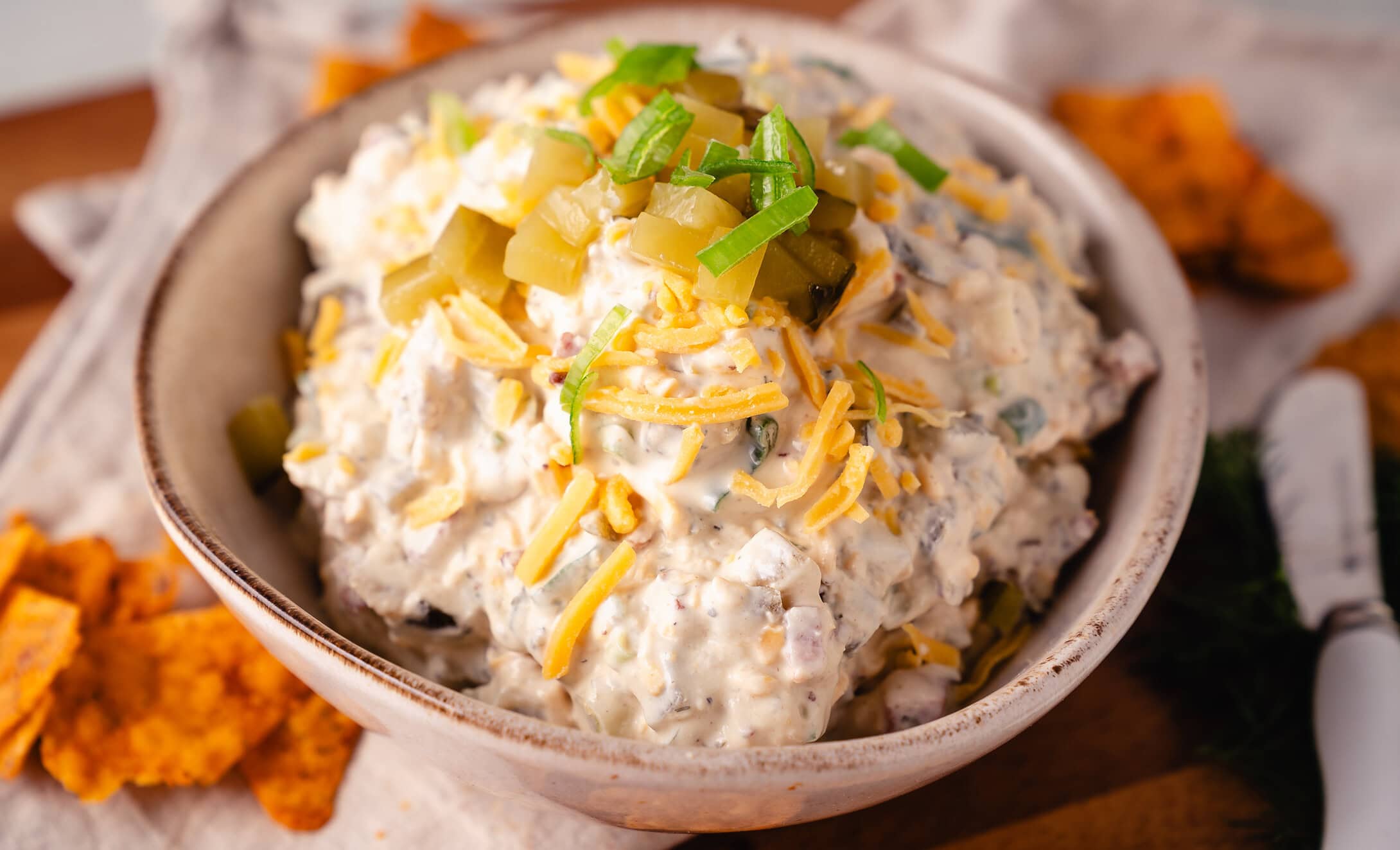 Pickle Dip saure Gurkendipp im Querformat mit geriebenem Cheddarkäse